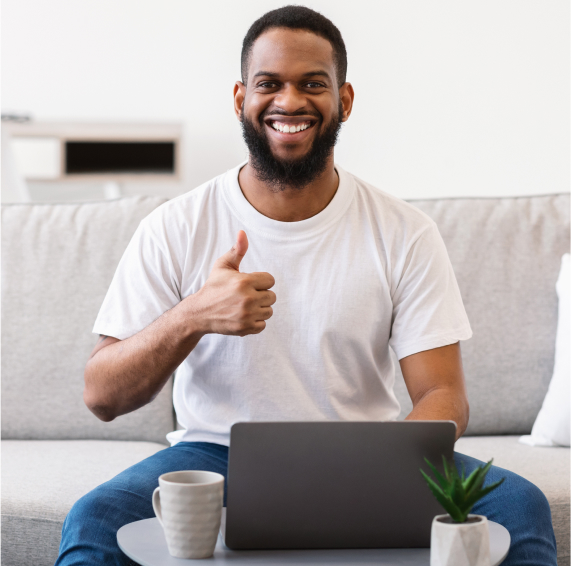 US Domain Registration 2 African man at laptop gesturing thumbs up sitting 2023 11 27 05 28 28 utc 1 2